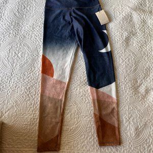 Onzie multi color yoga pants. Dark blue, tan & cream colors with sun & moon